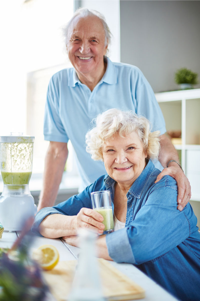 Elderly Alzheimer's couple drinking green juice