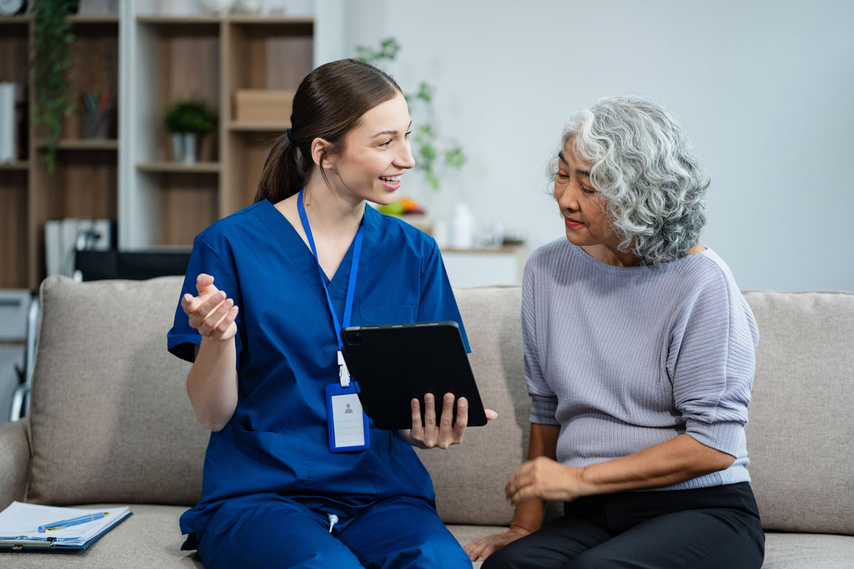 Healthcare professional discussing Alzheimer’s clinical trial investment and research opportunities with an older adult